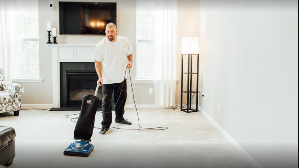 House cleaner vacuuming a floor